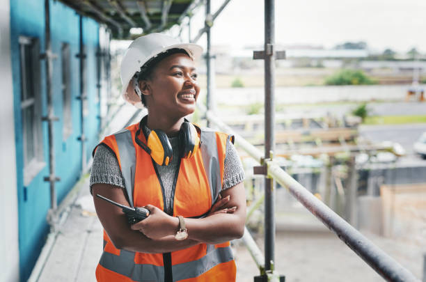 shot of a young woman working at a construction site